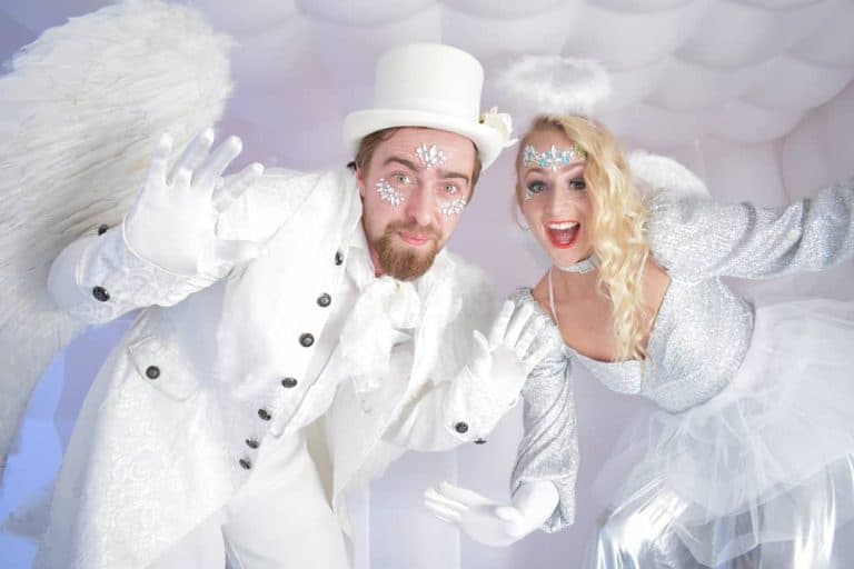 Guests dressed as angels posing in the photo booth