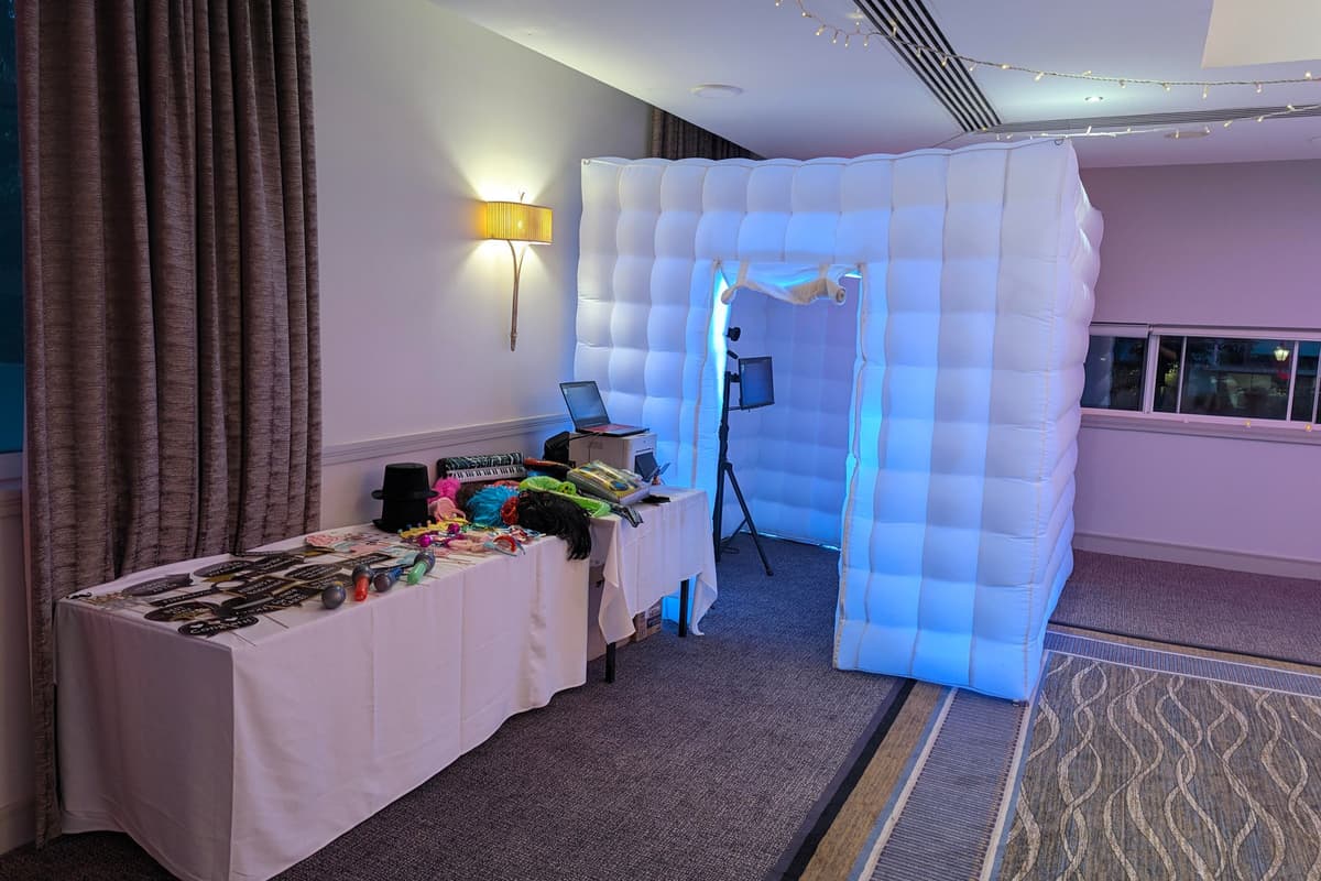 Our inflatable photo booth set up and ready for guests, with the props table alongside